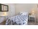 Cozy bedroom featuring a blue and white quilt, bedside tables, and a decorative wall hanging at 5803 Lindley Crescent Dr, Indian Trail, NC 28079