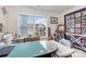 A carpeted bonus room has tables and sewing machines with a sunny window at 5803 Lindley Crescent Dr, Indian Trail, NC 28079