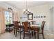 Formal dining room with elegant lighting, traditional decor, and a large window at 5803 Lindley Crescent Dr, Indian Trail, NC 28079