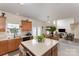 Spacious kitchen with an island, wooden cabinets, and a view into the living room at 5803 Lindley Crescent Dr, Indian Trail, NC 28079