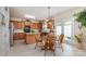 Well-lit kitchen with a central island, wooden cabinets, and adjacent breakfast area at 5803 Lindley Crescent Dr, Indian Trail, NC 28079