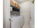 Well-organized laundry room with washer, dryer, and shelving for storage at 5803 Lindley Crescent Dr, Indian Trail, NC 28079