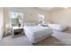 This carpeted main bedroom is bright and airy with many windows and two twin-sized beds at 5803 Lindley Crescent Dr, Indian Trail, NC 28079