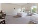 A carpeted main bedroom is bright and airy with many windows and two twin-sized beds at 5803 Lindley Crescent Dr, Indian Trail, NC 28079