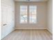 Bedroom with neutral carpet, two windows, white trim, and closet with white door at 606 Banter Ln # 30, Cramerton, NC 28032