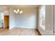 This dining room is bright and open with a modern chandelier and luxury vinyl flooring at 606 Banter Ln # 30, Cramerton, NC 28032