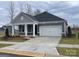 Charming single-story home features a covered front porch, gray siding, white trim, and a two-car garage at 606 Banter Ln # 30, Cramerton, NC 28032