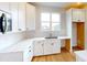 Bright kitchen features white cabinets, stainless steel appliances, light countertops, and a window at 606 Banter Ln # 30, Cramerton, NC 28032