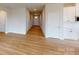 Living room features light wood floor, white walls and trim, and a view of entry door at 606 Banter Ln # 30, Cramerton, NC 28032