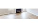 Living room with a fireplace, light wood floor, white walls and white trim at 606 Banter Ln # 30, Cramerton, NC 28032