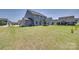 Large backyard with lush green grass and covered patio, great for outdoor activities at 6113 Russo Ct, Lancaster, SC 29720