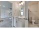 Bright bathroom with a vanity, stylish lighting, and tile flooring is conveniently located near the living area at 6113 Russo Ct, Lancaster, SC 29720