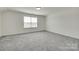 Bright bedroom with a window and neutral walls and carpet allows for personalization and offers comfortable space at 6113 Russo Ct, Lancaster, SC 29720