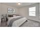 The bedroom has a serene ambiance with its neutral color palette, soft carpet, and natural light from a window at 6113 Russo Ct, Lancaster, SC 29720
