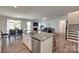 Open concept kitchen with island, stainless steel appliances, and adjoining dining and living spaces at 6113 Russo Ct, Lancaster, SC 29720