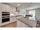 Modern kitchen featuring white cabinets, stainless steel appliances, and a gray countertop island at 6113 Russo Ct, Lancaster, SC 29720