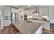 Spacious kitchen featuring white cabinets, stainless steel appliances, and a large kitchen island at 6113 Russo Ct, Lancaster, SC 29720