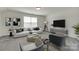 The living room is furnished with plush seating, modern decor, a large screen TV, and natural light, creating a cozy space at 6113 Russo Ct, Lancaster, SC 29720