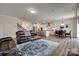 Open-concept living room and kitchen with hardwood floors and plenty of natural light at 6113 Russo Ct, Lancaster, SC 29720