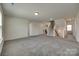 Open living area features plush carpeting, a staircase and access to other rooms at 6113 Russo Ct, Lancaster, SC 29720