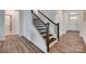Elegant staircase with dark wood steps and railing, complemented by white risers and walls at 6113 Russo Ct, Lancaster, SC 29720