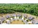 Aerial view highlighting the neighborhood's circular layout with mature trees and green spaces at 7549 Short Putt Ct, Charlotte, NC 28215