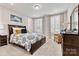 Cozy bedroom with large windows, shutters, and a comfortable bed, perfect for relaxation at 7549 Short Putt Ct, Charlotte, NC 28215