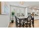 Formal dining room featuring modern chandelier, large windows with shutters, and access to kitchen at 7549 Short Putt Ct, Charlotte, NC 28215