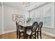 Elegant dining room with chandelier, large windows with shutters, and stylish decor at 7549 Short Putt Ct, Charlotte, NC 28215