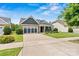 Lovely single Gathering home with a stone facade, attractive dormers and a well manicured lawn at 7549 Short Putt Ct, Charlotte, NC 28215