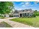 Charming front exterior with beautiful landscaping and a cozy front porch, perfect for relaxing at 7549 Short Putt Ct, Charlotte, NC 28215