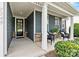 Relaxing front porch adorned with seating, potted plants, and elegant columns, great for outdoor enjoyment at 7549 Short Putt Ct, Charlotte, NC 28215