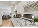 Stylish kitchen with modern appliances, granite countertops, white cabinets, and dining area in view at 7549 Short Putt Ct, Charlotte, NC 28215