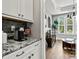 Kitchen coffee bar with granite countertops and a glimpse into a cozy sitting room area at 7549 Short Putt Ct, Charlotte, NC 28215