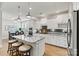 Modern kitchen featuring granite countertops, white cabinetry, stainless steel appliances, and a breakfast bar at 7549 Short Putt Ct, Charlotte, NC 28215