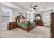 Spacious bedroom with ceiling fan, large windows providing natural light, and elegant furniture at 7549 Short Putt Ct, Charlotte, NC 28215