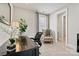 Comfortable home office featuring a wooden desk, chair, and sitting area with a bright window at 7549 Short Putt Ct, Charlotte, NC 28215
