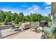 Outdoor patio space with lush landscaping, comfortable seating, and a barbecue grill at 7549 Short Putt Ct, Charlotte, NC 28215