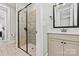 Tiled walk-in shower with glass enclosure, accented by a modern vanity and neutral wall colors at 7549 Short Putt Ct, Charlotte, NC 28215