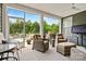 Inviting screened-in porch with wicker furniture and a view of the landscaped backyard at 7549 Short Putt Ct, Charlotte, NC 28215