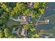 Expansive aerial view showcasing the property's prime location, lush landscaping, and private waterfront access at 7861 Live Oaks Dr, Denver, NC 28037
