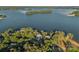 Breathtaking aerial view of a lakeside estate, surrounded by lush greenery and sparkling blue waters at 7861 Live Oaks Dr, Denver, NC 28037