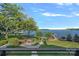 Expansive backyard with lake views, fire pit area, and lush landscaping for outdoor enjoyment at 7861 Live Oaks Dr, Denver, NC 28037