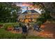 Inviting backyard featuring a fire pit surrounded by Adirondack chairs, perfect for gatherings at 7861 Live Oaks Dr, Denver, NC 28037