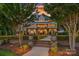 Stunning backyard with manicured lawn, brick patio, and lush landscaping creating a serene outdoor space at 7861 Live Oaks Dr, Denver, NC 28037