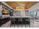 A modern bar features a beautiful chandelier, black cabinets and a marble countertop at 7861 Live Oaks Dr, Denver, NC 28037