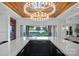 The bar features a marble countertop, a view of the backyard, black cabinets, and a wood ceiling at 7861 Live Oaks Dr, Denver, NC 28037