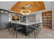 The bar features a beautiful chandelier, black cabinets, comfortable seating, and a marble countertop at 7861 Live Oaks Dr, Denver, NC 28037