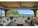 Relaxing covered patio with comfortable seating and panoramic views of the lake at 7861 Live Oaks Dr, Denver, NC 28037