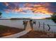 Scenic view of the private dock at sunset, offering tranquil access to the expansive lake at 7861 Live Oaks Dr, Denver, NC 28037